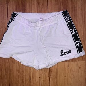 White shorts with the print love